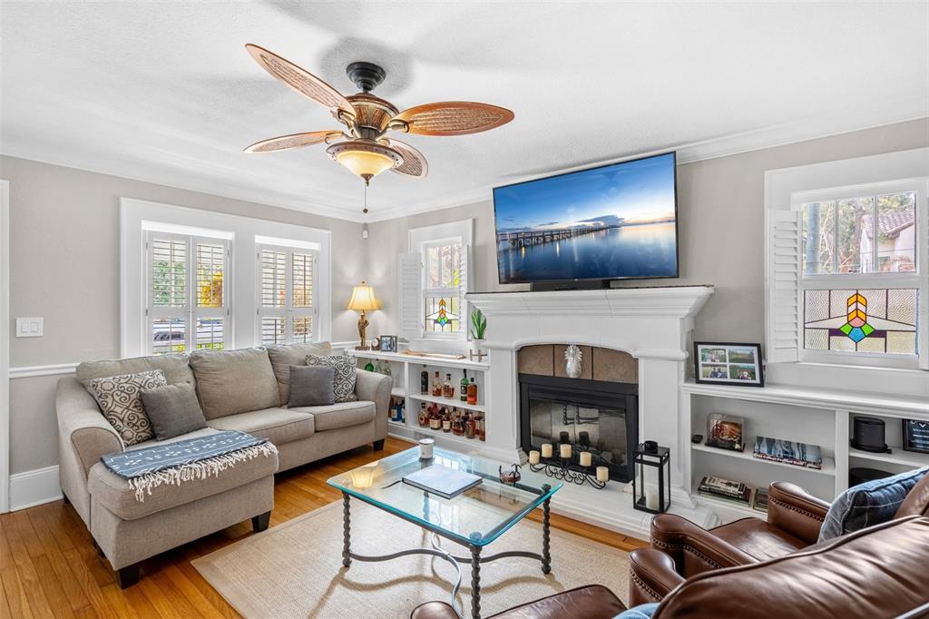 1003 East Jackson Street Orlando, FL 32801 - Photo 3 of 27 a living room with furniture a fireplace and a flat screen tv
