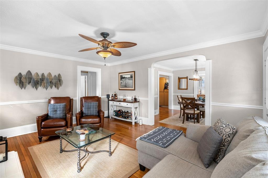 1003 East Jackson Street Orlando, FL 32801 - Photo 5 of 27 a living room with furniture a rug and a chandelier