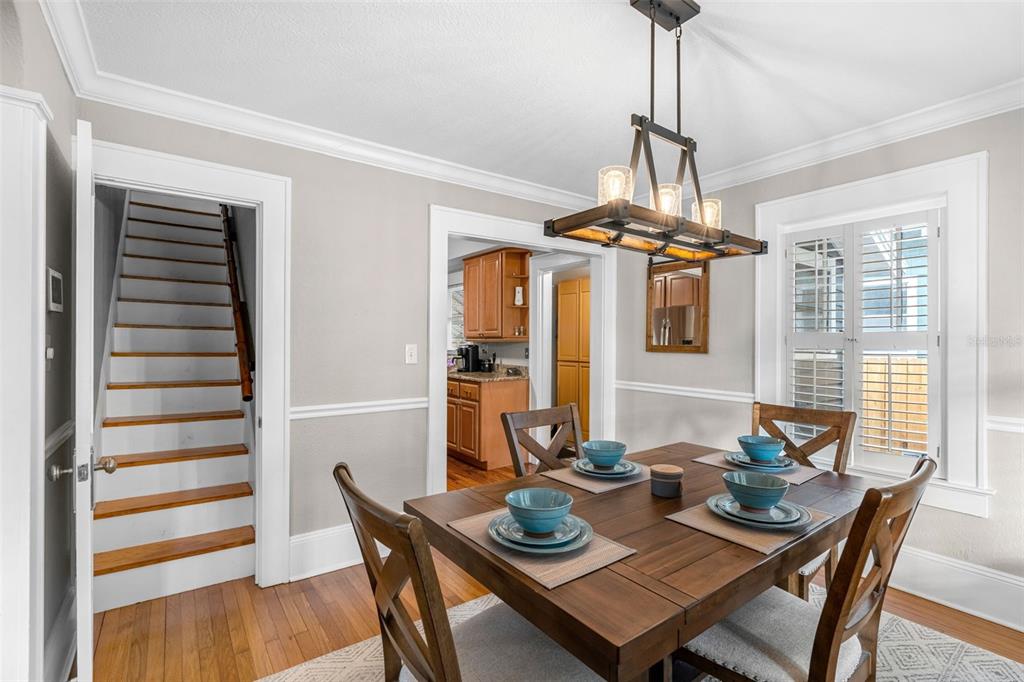 1003 East Jackson Street Orlando, FL 32801 - Photo 7 of 27 a view of a dining room with furniture wooden floor and chandelier