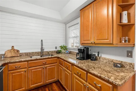 a kitchen with stainless steel appliances granite countertop a sink and a cabinets