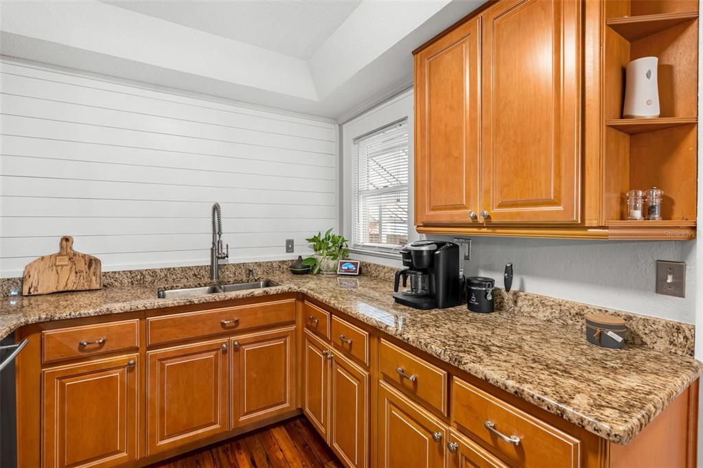 1003 East Jackson Street Orlando, FL 32801 - Photo 9 of 27 a kitchen with stainless steel appliances granite countertop a sink and a cabinets