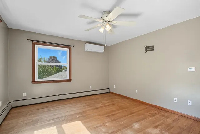wooden floor in an empty room with a window