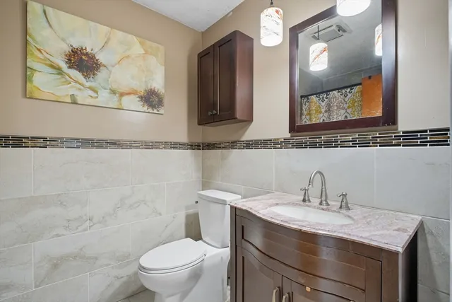 a white toilet sitting next to a shower curtain