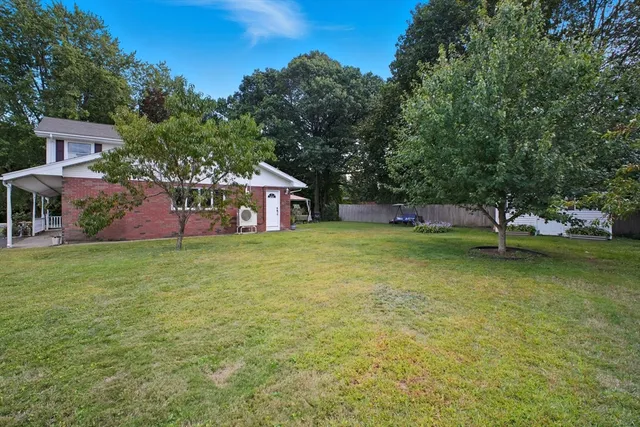 a view of a house with a yard porch and sitting area