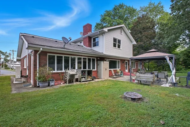 a front view of a house with a yard table and chairs