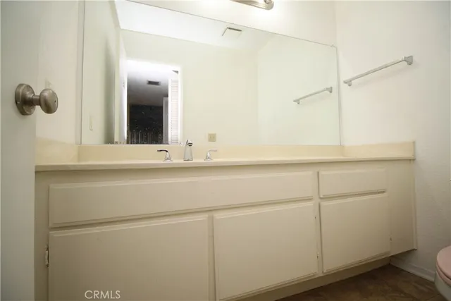 a spacious bathroom with a double vanity sink mirror and toilet