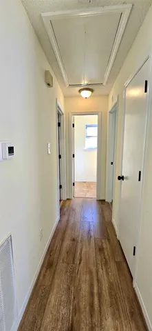 a view of hallway with wooden floor