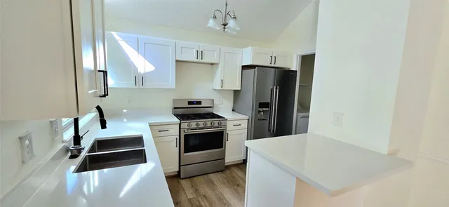 a kitchen with cabinets and stainless steel appliances