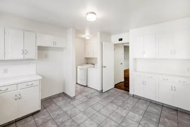 a view of balcony with two chairs and a potted plant