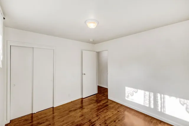 a walk in closet with lots of clutter