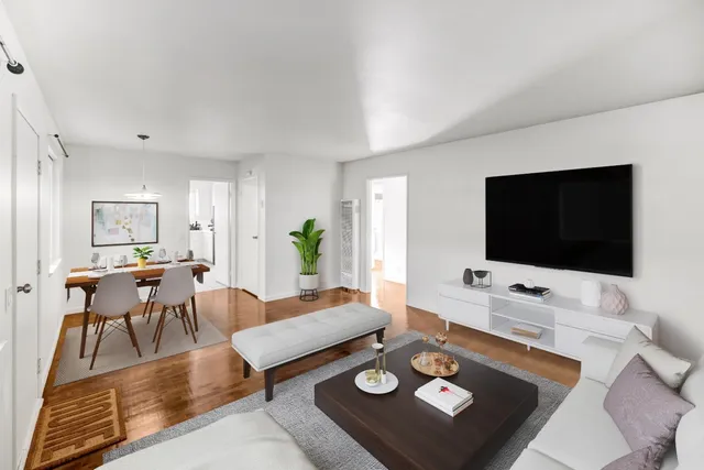a kitchen with white cabinets and window
