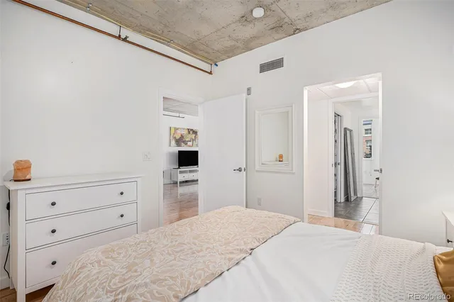 a bedroom with a bed and a dresser