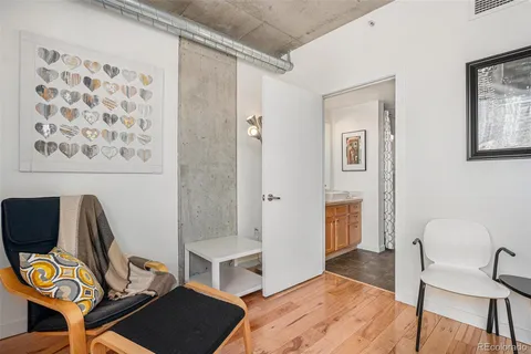 a view of a workspace with furniture and wooden floor
