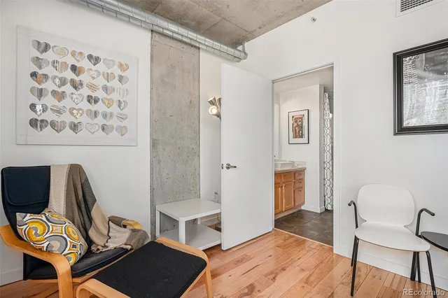 a view of a workspace with furniture and wooden floor