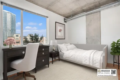 a bedroom with a bed window and chair