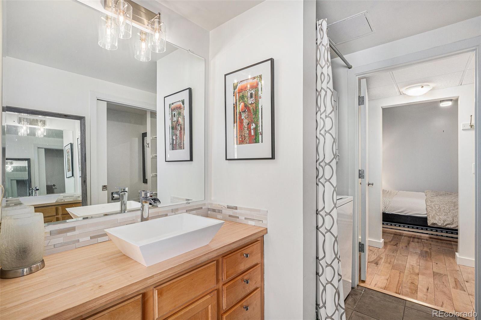 1475 Delgany Street, Unit 304 Denver, CO 80202 - Photo 15 of 28 a bathroom with a sink and a mirror