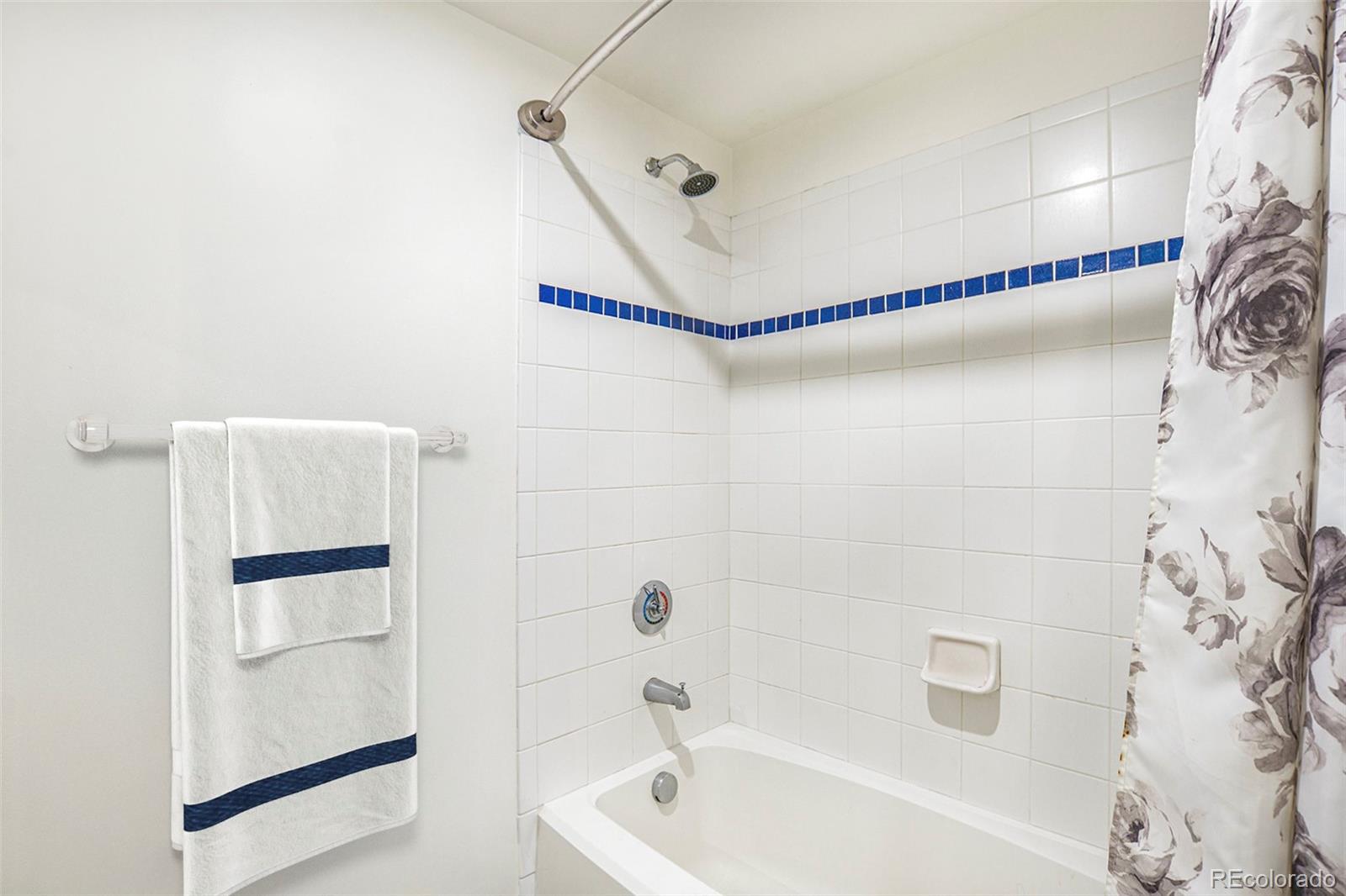 1475 Delgany Street, Unit 304 Denver, CO 80202 - Photo 18 of 28 a bathroom with a bathtub and a shower