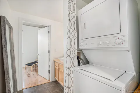 a view of a city from a balcony with furniture