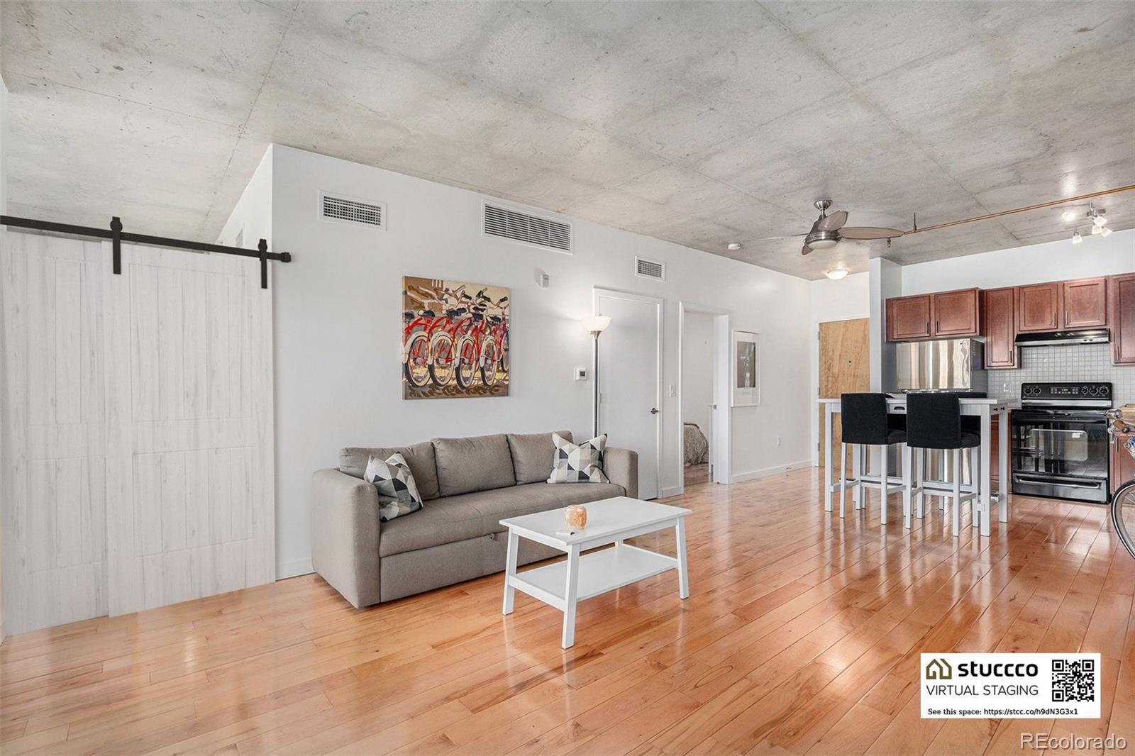 1475 Delgany Street, Unit 304 Denver, CO 80202 - Photo 5 of 28 a living room with furniture and a view of kitchen