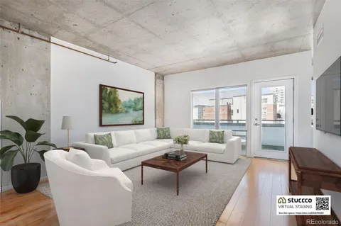 a living room with furniture potted plant and windows