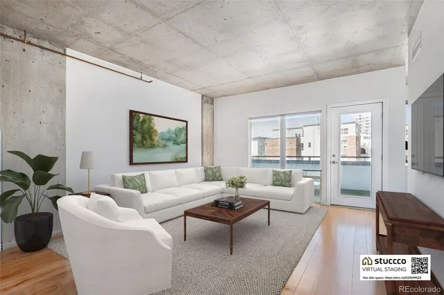 a living room with furniture potted plant and windows