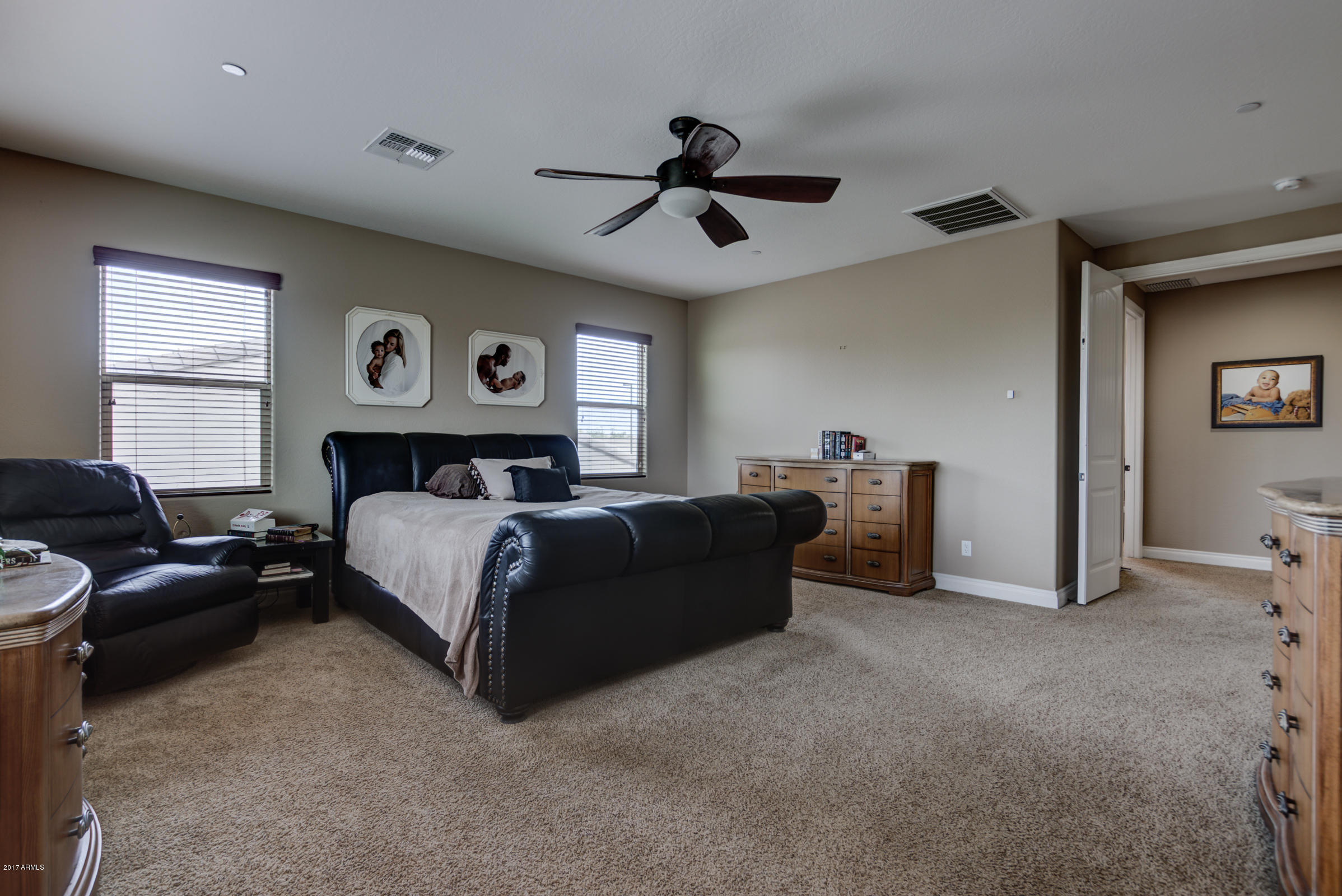 2906 East Blue Sage Road Gilbert, AZ 85297 - Photo 24 of 41 a spacious bedroom with a bed and a ceiling fan