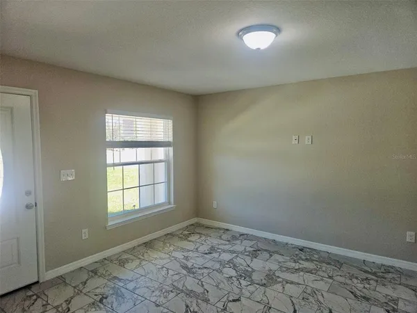 a view of an empty room and window
