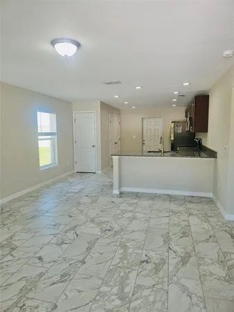 a view of a kitchen with a refrigerator and a sink