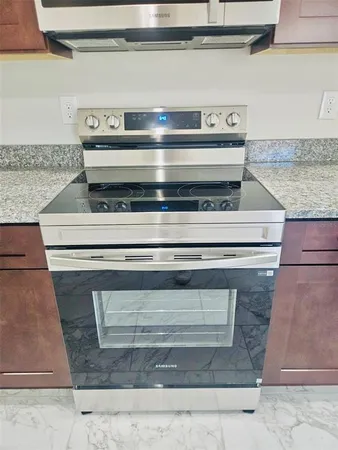 a stove top oven sitting inside of a kitchen