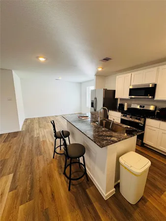 a kitchen with a table and chairs