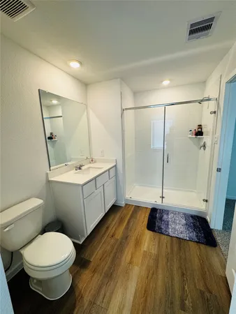 a bathroom with a sink toilet and shower