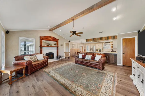a living room with furniture a fireplace and a table