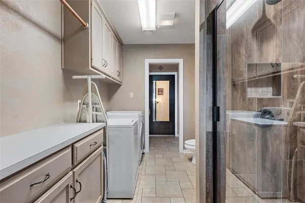 a kitchen with a refrigerator and cabinets