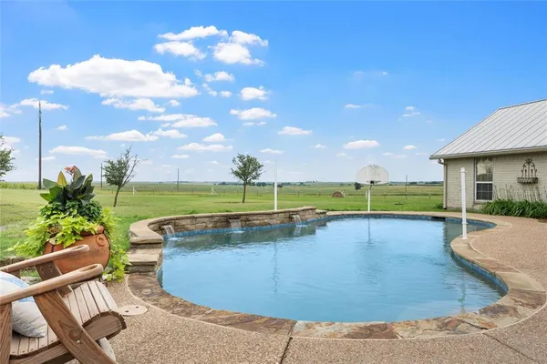a view of a swimming pool with a lounge chairs