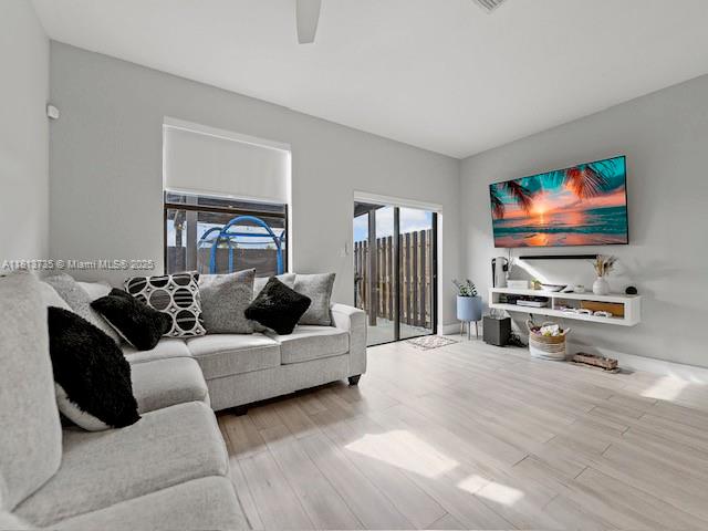 18058 Southwest 147th Court Miami, FL 33187 - Photo 11 of 27 a living room with furniture and a flat screen tv