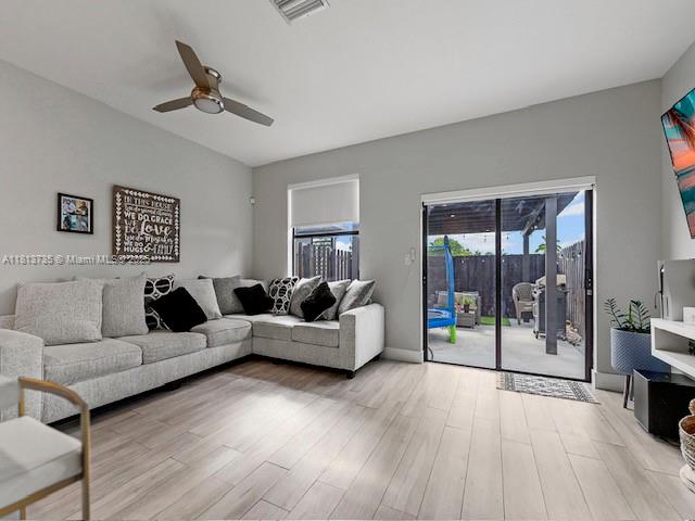 18058 Southwest 147th Court Miami, FL 33187 - Photo 12 of 27 a living room with furniture and a floor to ceiling window