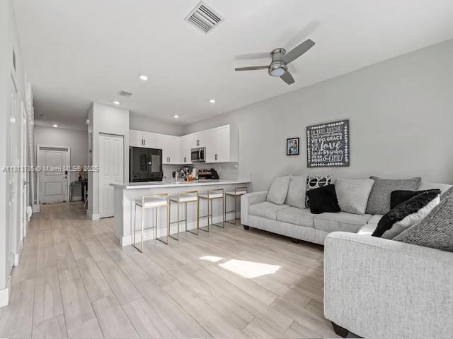 18058 Southwest 147th Court Miami, FL 33187 - Photo 13 of 27 a living room with furniture and a wooden floor