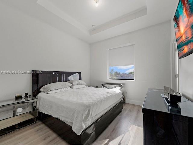 18058 Southwest 147th Court Miami, FL 33187 - Photo 15 of 27 a bedroom with a bed and a flat screen tv