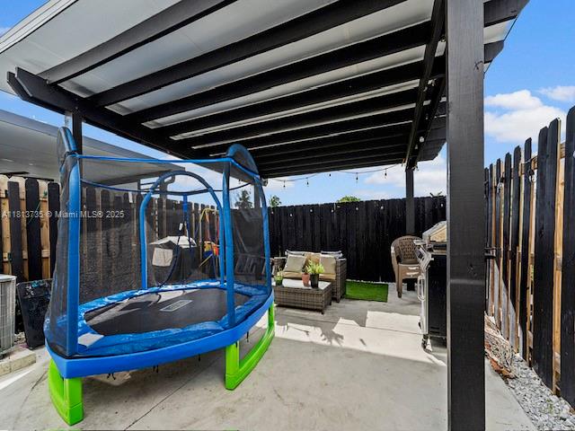 18058 Southwest 147th Court Miami, FL 33187 - Photo 21 of 27 a view of a chairs and tables in the back yard of the house