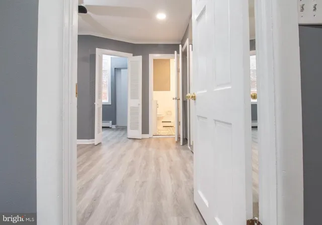 a view of a room with wooden floor and window
