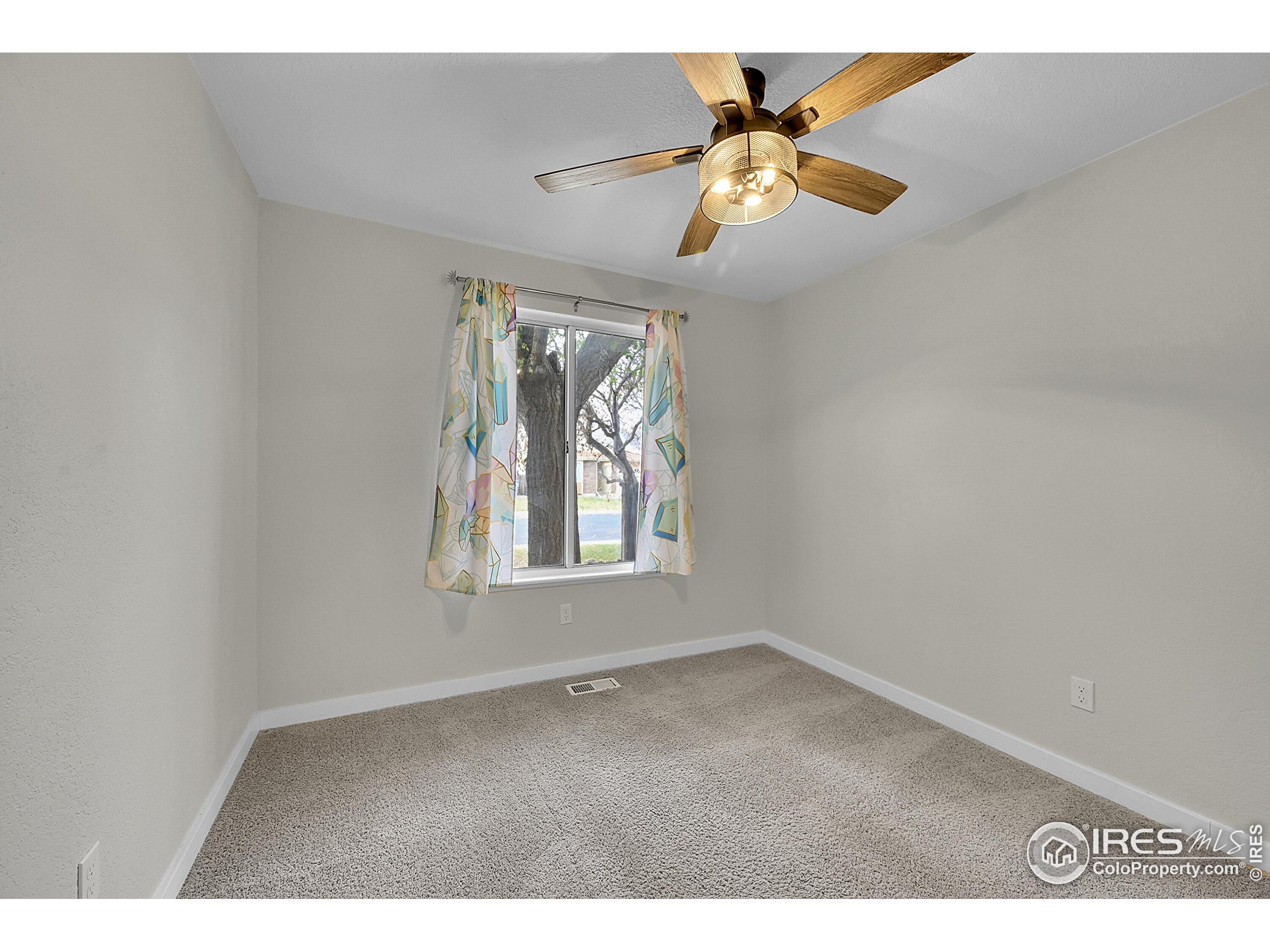 1836 Rice Street Longmont, CO 80501 - Photo 19 of 46 an empty room with windows and fan