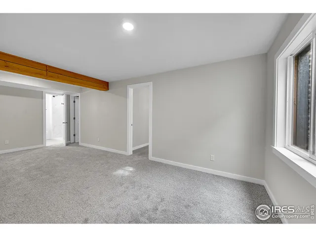 a view of an empty room and a window