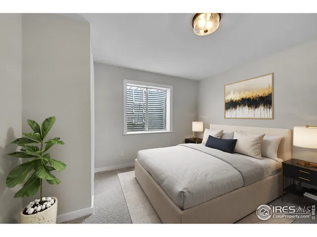 a bedroom with a balcony a bed and a plant