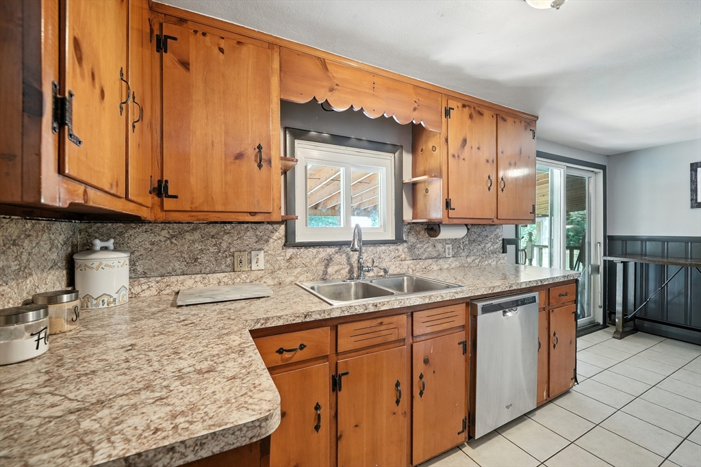 122 Drexel Street Springfield, MA 01104 - Photo 12 of 34 a kitchen with stainless steel appliances granite countertop a sink stove and cabinets