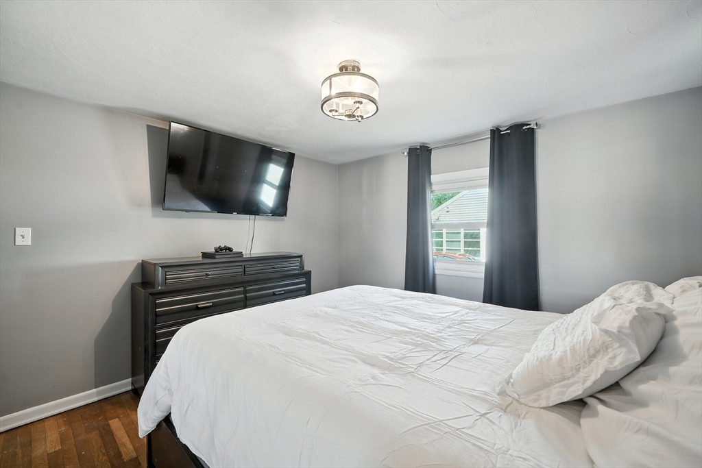 122 Drexel Street Springfield, MA 01104 - Photo 15 of 34 a bedroom with a bed and a flat screen tv
