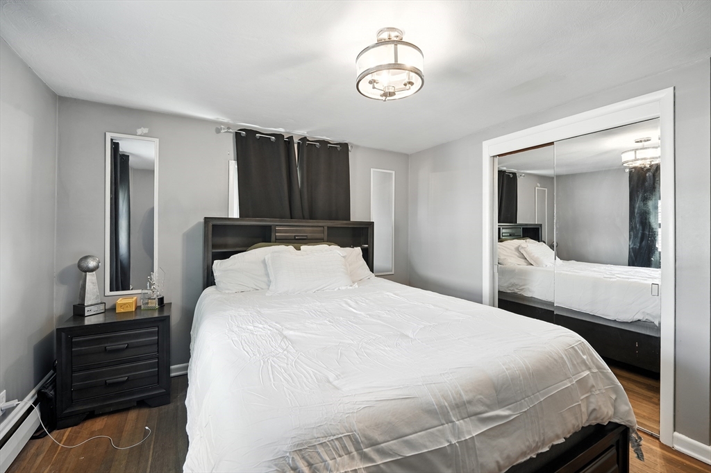 122 Drexel Street Springfield, MA 01104 - Photo 16 of 34 a bedroom with a bed and a chandelier