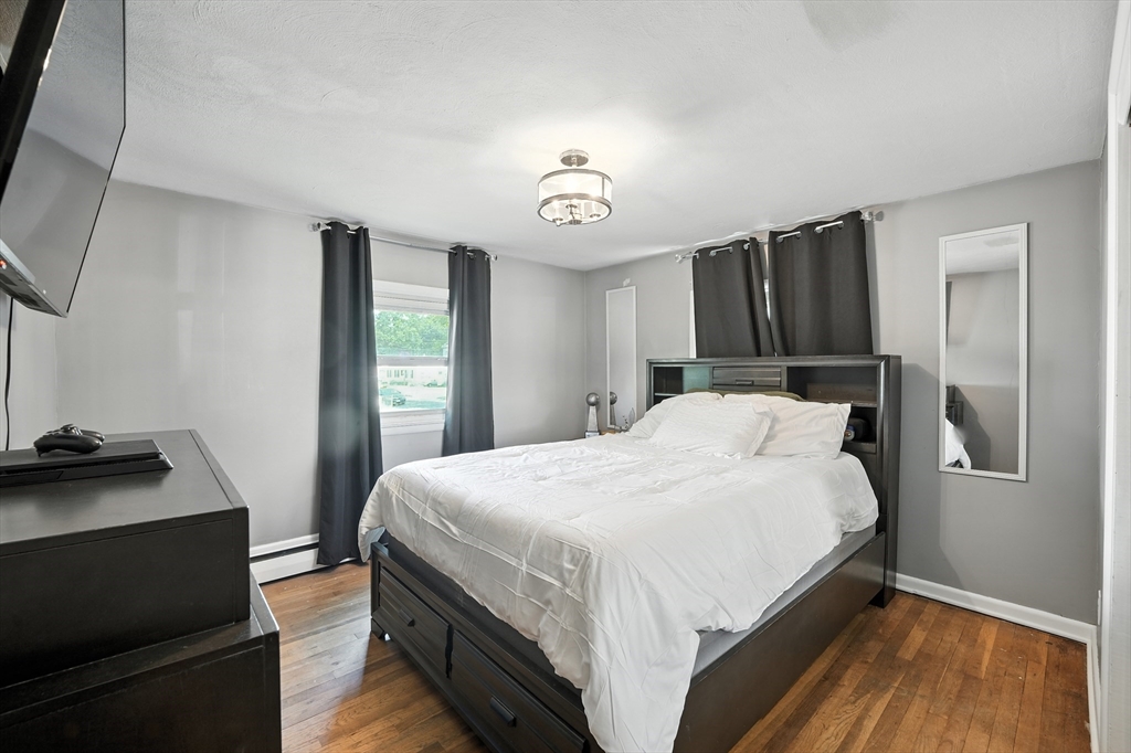 122 Drexel Street Springfield, MA 01104 - Photo 17 of 34 a bedroom with a bed and a dresser