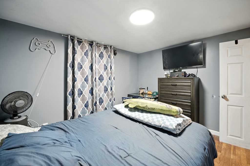 122 Drexel Street Springfield, MA 01104 - Photo 18 of 34 a bedroom with a bed and a flat screen tv