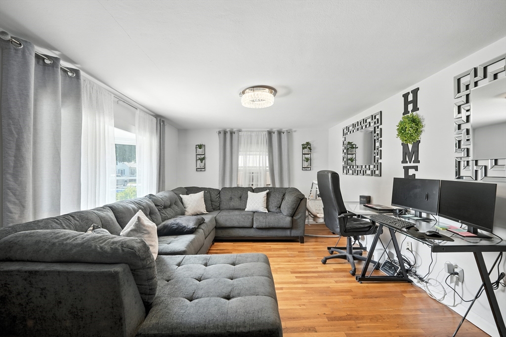 122 Drexel Street Springfield, MA 01104 - Photo 24 of 34 a living room with furniture and wooden floor