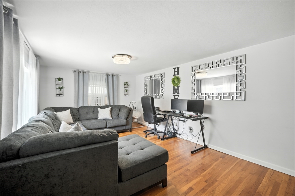 122 Drexel Street Springfield, MA 01104 - Photo 25 of 34 a living room with furniture and a wooden floor
